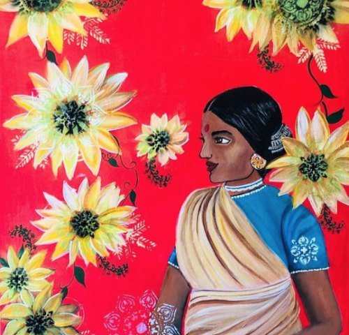 A woman in a cream and gold saree standing among sunflowers on a red ground