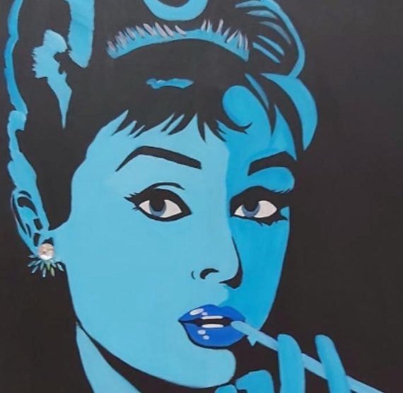 Pop-art portrait of Audrey Hepburn in cyan and black