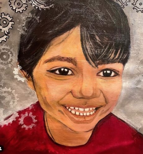 A laughing child in a red top