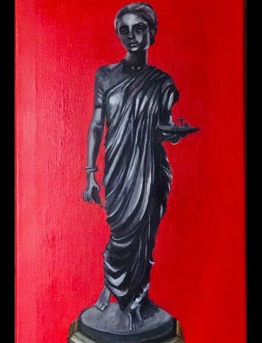 A dark bronze lamp-bearing figure against a red background