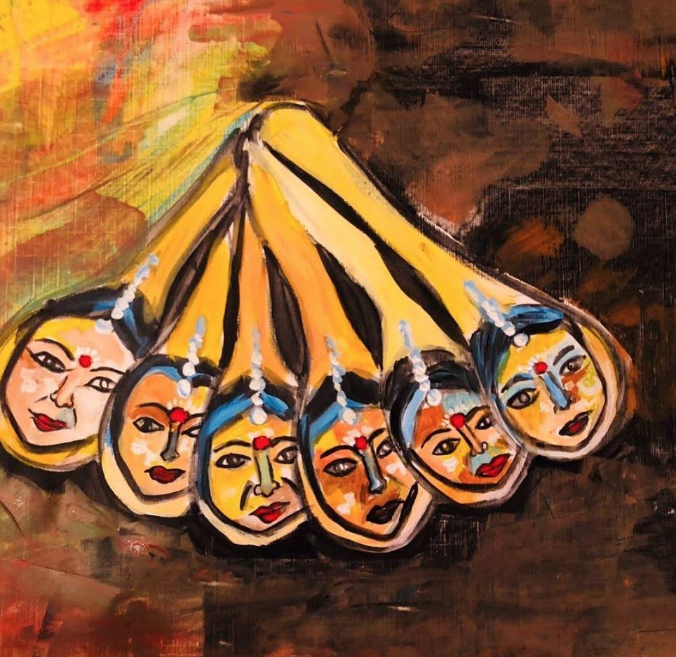 Six small painted faces fanned out on golden spokes