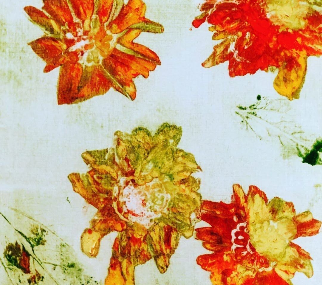 Orange and yellow blooms scattered on a pale ground