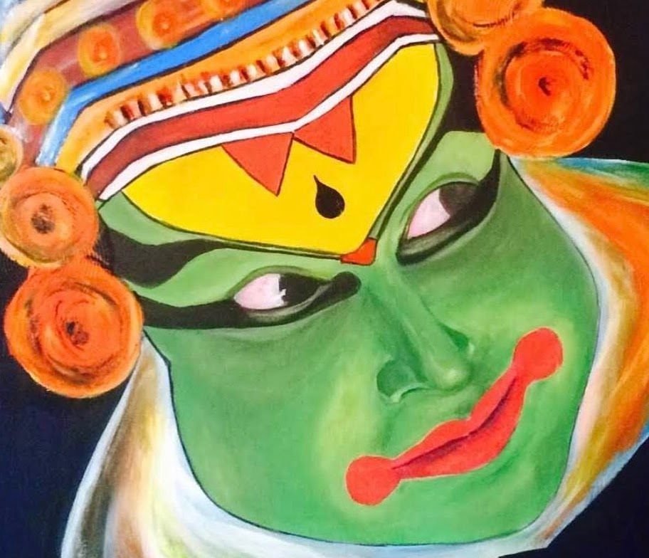 Kathakali dancer in green pacha make-up, crowned and framed in orange, red lips and white-lined eyes