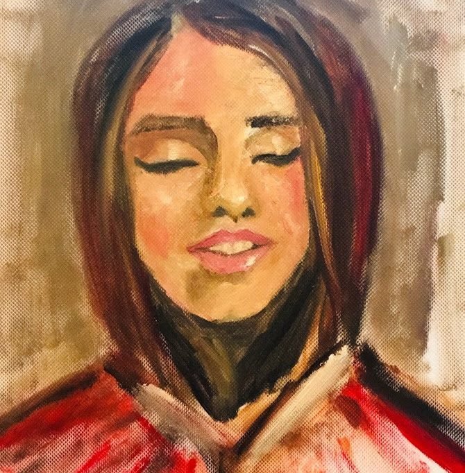 A young woman with closed eyes in warm light