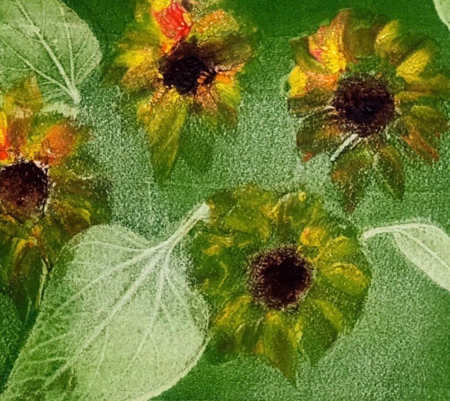 Sunflowers and translucent leaves on a green ground